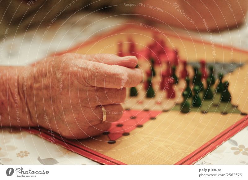 Pensioner plays Halma Lifestyle Leisure and hobbies Playing Female senior Woman Male senior Man Grandparents Senior citizen Grandfather Grandmother Adults Hand