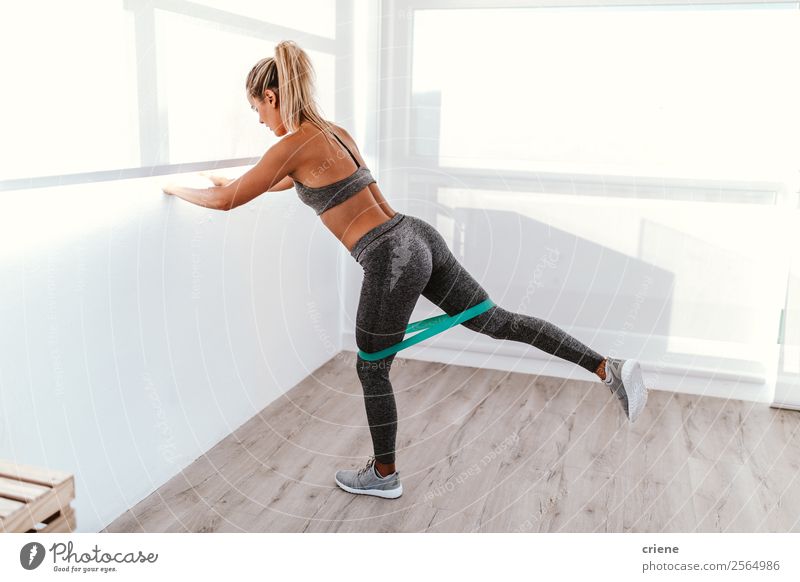 athletic young woman doing excercise with elastic band - a Royalty Free  Stock Photo from Photocase