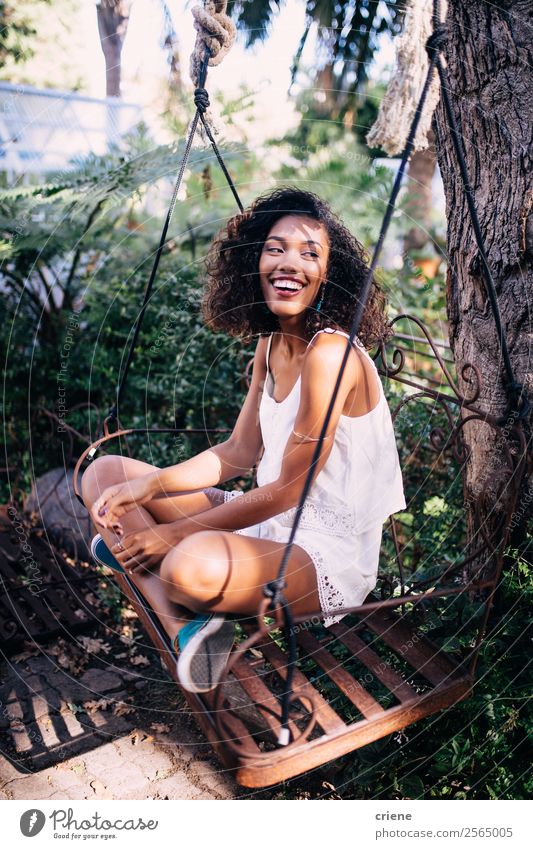 african young woman sitting on swing in garden Lifestyle Happy Beautiful Relaxation Summer Garden Human being Woman Adults Nature Plant Tree To enjoy Smiling