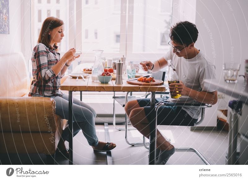 young couple eating breakfast together in kitchen Vegetable Eating Breakfast Coffee Joy Beautiful Chair Table Kitchen To talk Human being Woman Adults Man