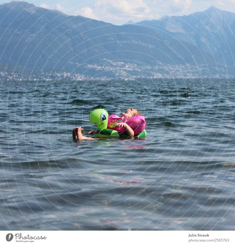 Child enjoy swimming Swimming & Bathing Feminine Toddler 1 Human being 1 - 3 years Water Clouds Summer Beautiful weather Mountain Lake Lago Maggiore Italy