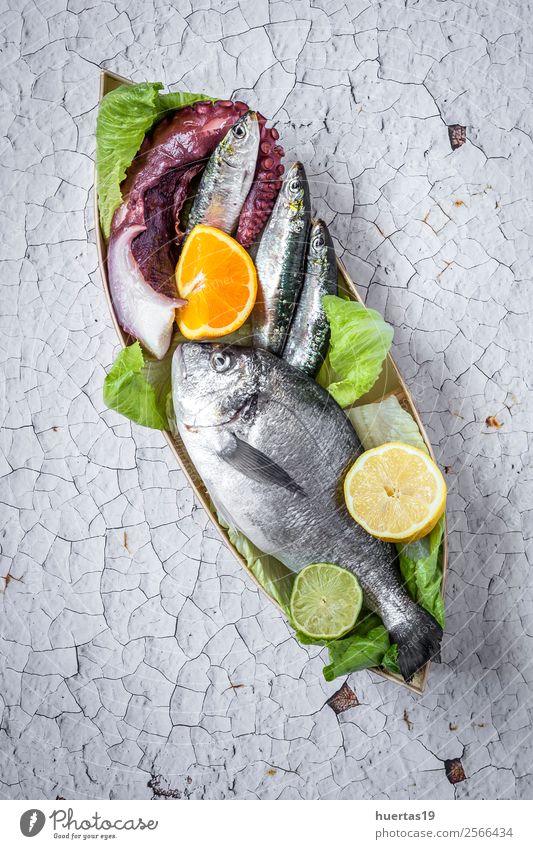 Fresh raw fish on wooden board Food Fish Seafood Fruit Dinner Buffet Brunch Diet Ocean Gastronomy Cool (slang) Delicious Natural Sardine Octopus Golden fish