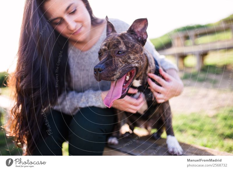 young woman with her dog Lifestyle Happy Beautiful Woman Adults Friendship Nature Animal Grass Park Pet Dog Smiling Cute Green Joy Happiness Trust Safety