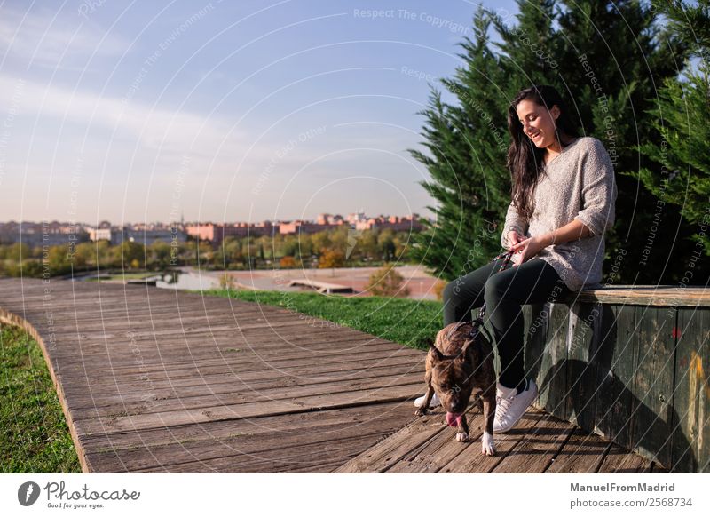 young woman sitting with her dog Lifestyle Happy Beautiful Woman Adults Friendship Nature Animal Grass Park Pet Dog Smiling Sit Cute Green Trust