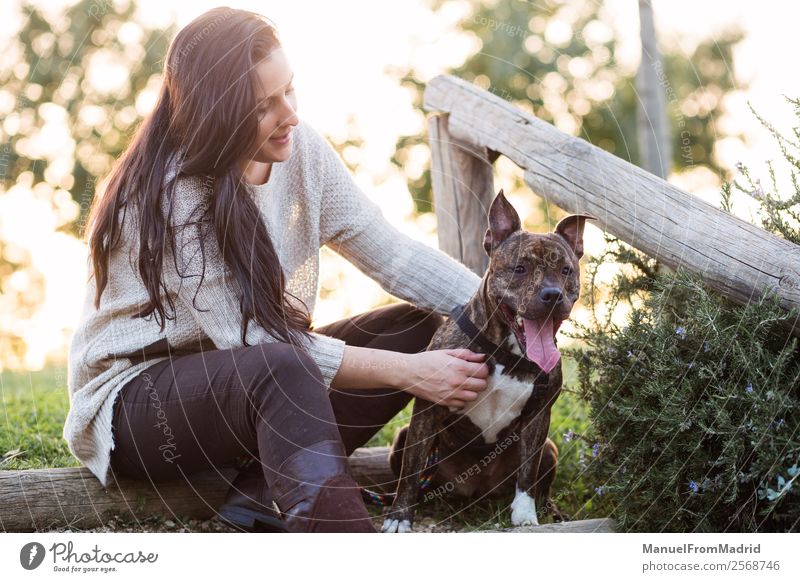 young woman with her dog at a park Lifestyle Happy Beautiful Woman Adults Friendship Nature Animal Grass Park Pet Dog Smiling Cute Green Happiness Trust Safety