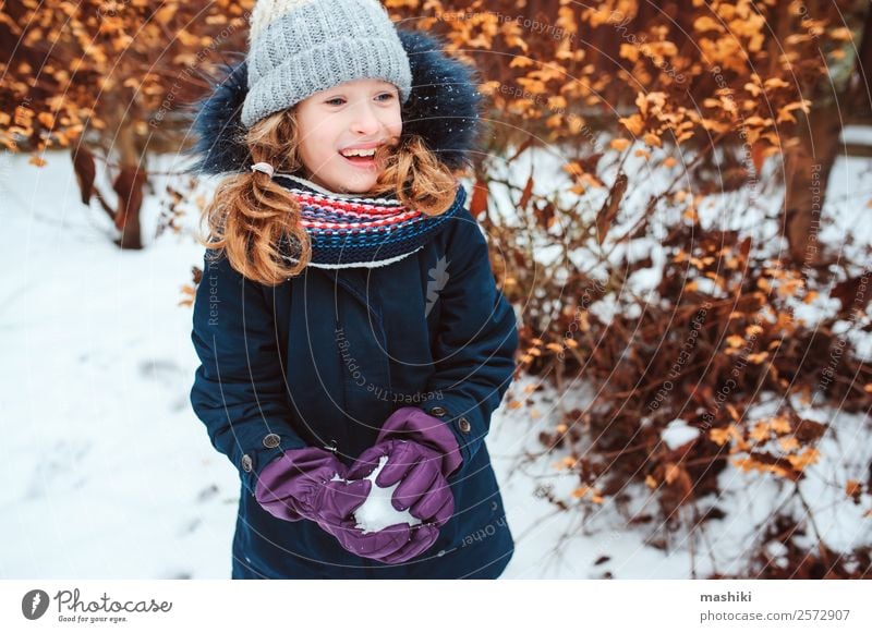 winter portrait of happy kid girl playing snowballs Lifestyle Joy Playing Vacation & Travel Winter Snow Garden Child Nature Weather Warmth Park Clothing Gloves
