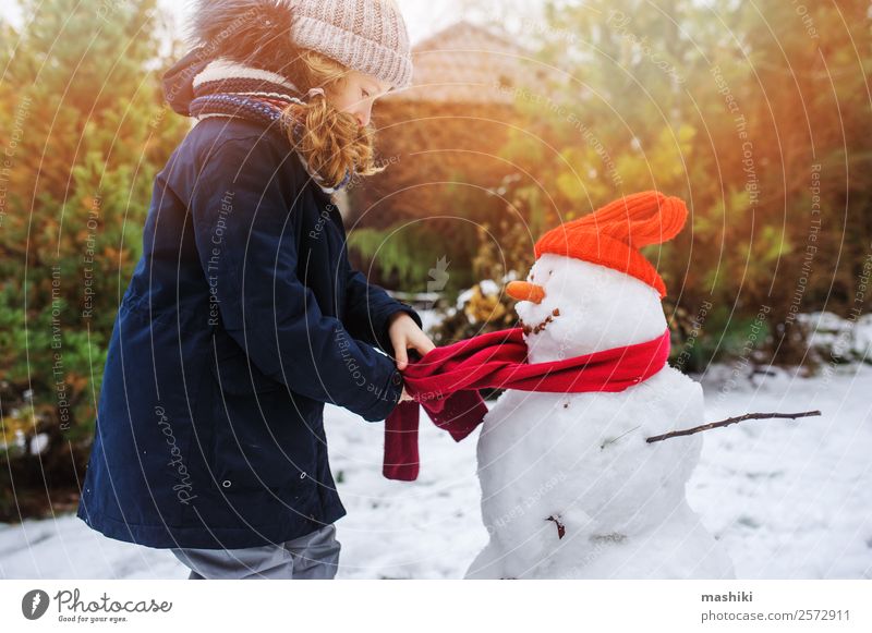 happy kid girl making snow man Joy Leisure and hobbies Playing Vacation & Travel Winter Snow Garden Child Nature Weather Park Clothing Make Snowman walk Action