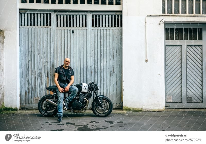 Biker posing with a motorcycle Lifestyle Style Trip Engines Human being Man Adults Street Vehicle Motorcycle Bald or shaved head Smiling Sit Authentic Retro