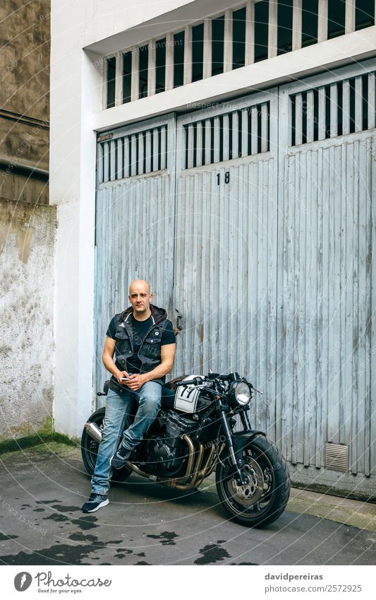 Biker posing with a motorcycle Lifestyle Style Trip Engines Human being Man Adults Street Vehicle Motorcycle Bald or shaved head Sit Authentic Retro Black Pride
