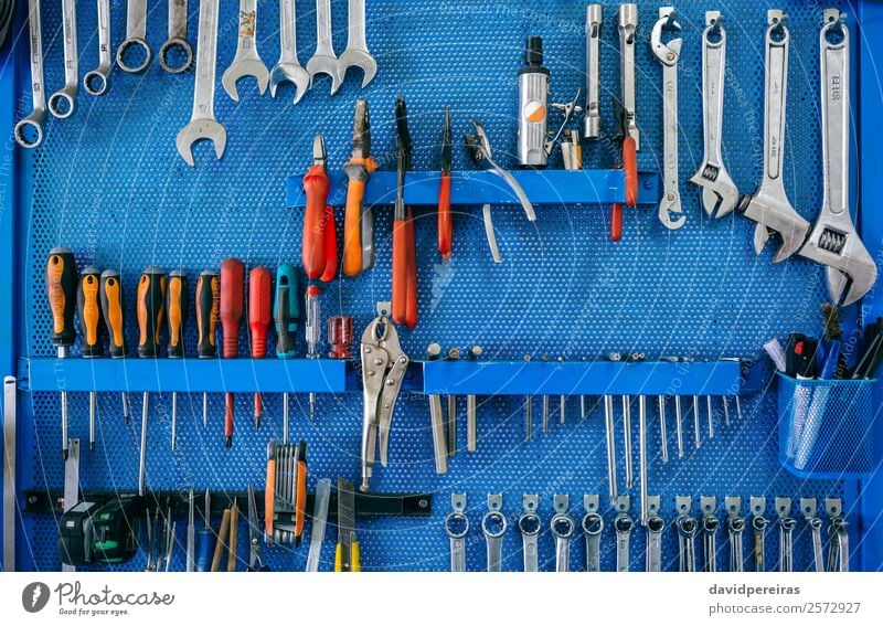 Background with tool board Work and employment Scissors Engines Vehicle Motorcycle Blue background Mechanical workshop Organized Set motorbike Cutter Knife