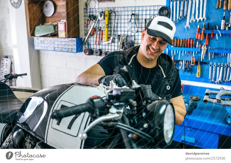Mechanic cleaning a motorcycle Lifestyle Style Happy Work and employment Engines Human being Man Adults Vehicle Motorcycle Cloth Smiling Authentic Retro vintage