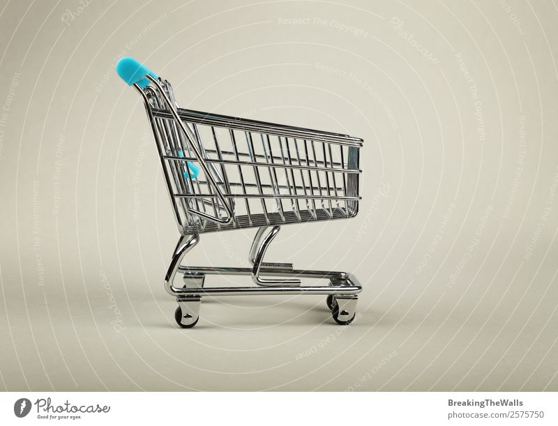 Close up empty supermarket shopping cart over grey Shopping Economy Industry Trade Logistics Business Toys Metal Modern Gray Retail sector trolley Supermarket