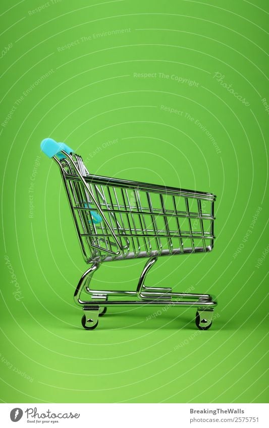 Close up empty toy metal supermarket shopping cart Shopping Children's game Economy Logistics Business Toys Metal Plastic Green Colour Trade Retail sector Side