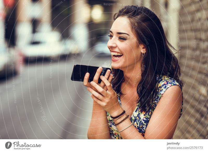 Smiling young woman recording voice note in her smart phone outdoors. Lifestyle Style Happy Beautiful Hair and hairstyles Telephone PDA Technology Human being