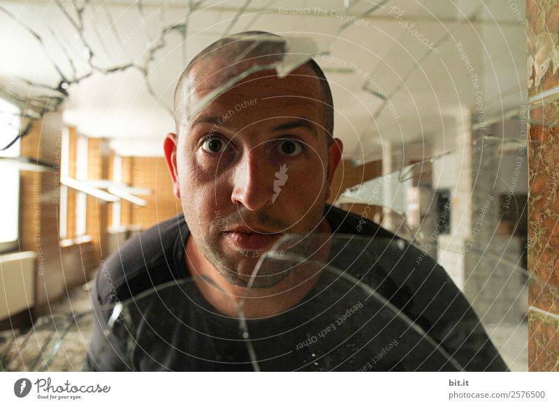 Man looks through old, broken glass pane. School Craftsperson Workplace Masculine Young man Youth (Young adults) Adults Glass Fiasco Adversity Curiosity Protest