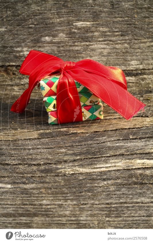 colourful christmas parcels packed with christmas paper with red bow, on  rustic wood. Christmas presents, lie nicely decorated with ribbon on wooden  table. Many Christmas parcels wrapped with wrapping paper with Christmas