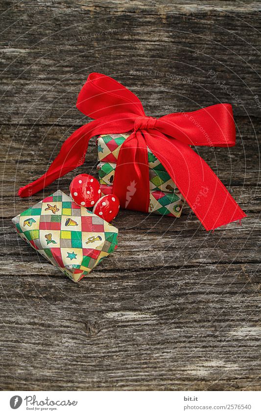 Christmas parcel with red bow on wooden background. Feasts & Celebrations Christmas & Advent Brown Multicoloured Red Christmas decoration Christmas gift
