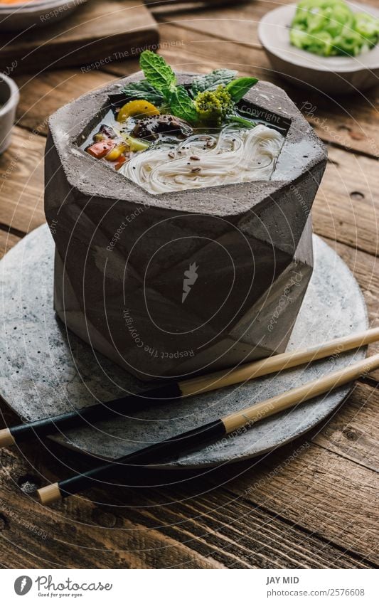 Geometric bowl of Asian Noodle Soup with chopsticks Food Meat Vegetable Dough Baked goods Stew Lunch Dinner Asian Food Bowl Lifestyle Table Wood Fresh Delicious