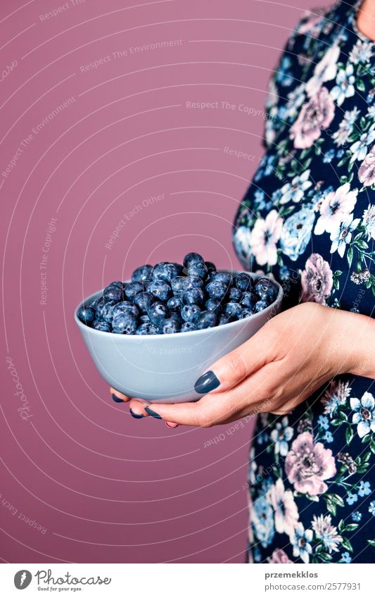 Woman holding bowl filled with fresh blueberries Food Fruit Nutrition Eating Organic produce Vegetarian diet Diet Bowl Lifestyle Summer Human being Young woman