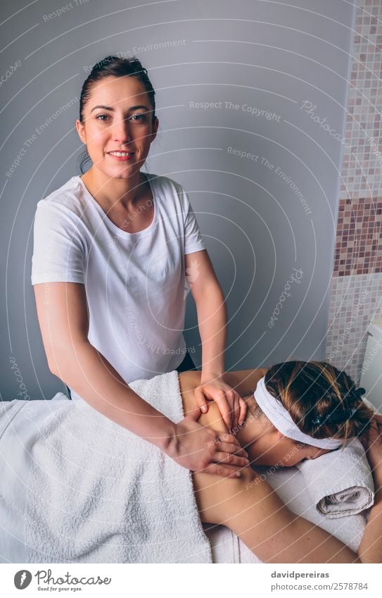 Female massage therapist doing treatment to woman in clinic Happy Beautiful Body Skin Health care Medical treatment Medication Wellness Relaxation Spa Massage