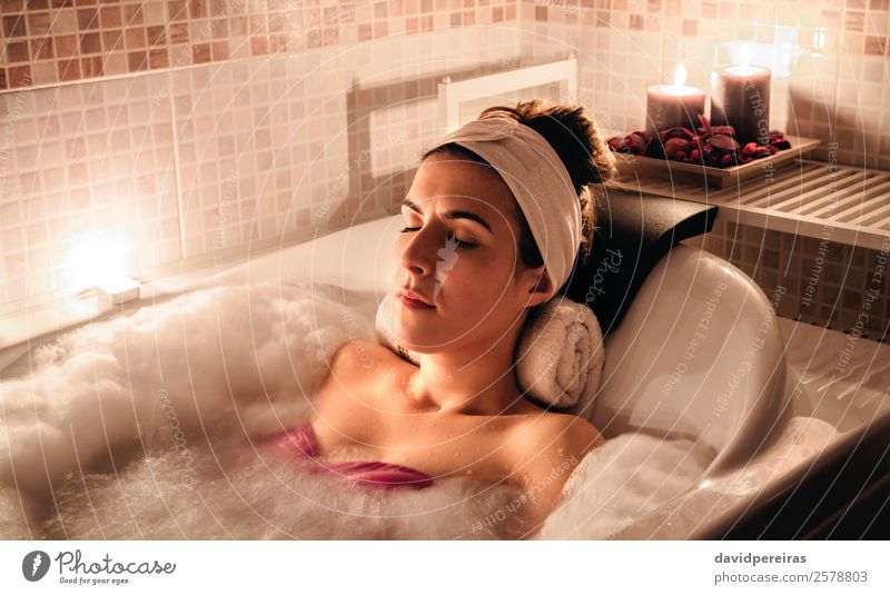 Women's legs in the bathtub, bathing with bubble bath foam top view,  relaxtion beauty spa concept - a Royalty Free Stock Photo from Photocase