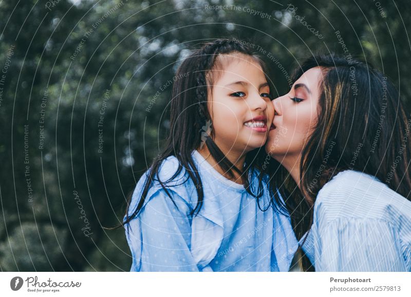 Happy mother kissing her daughter enjoying a winter afternoon Lifestyle Leisure and hobbies Summer Human being Feminine Child Baby Girl Young woman