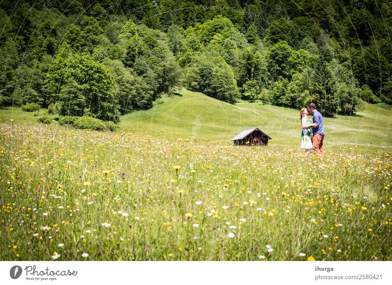 happy lovers on Holiday in the alps mountains adventure background beautiful cheerful countryside couple europe female field flower forest girl green hands