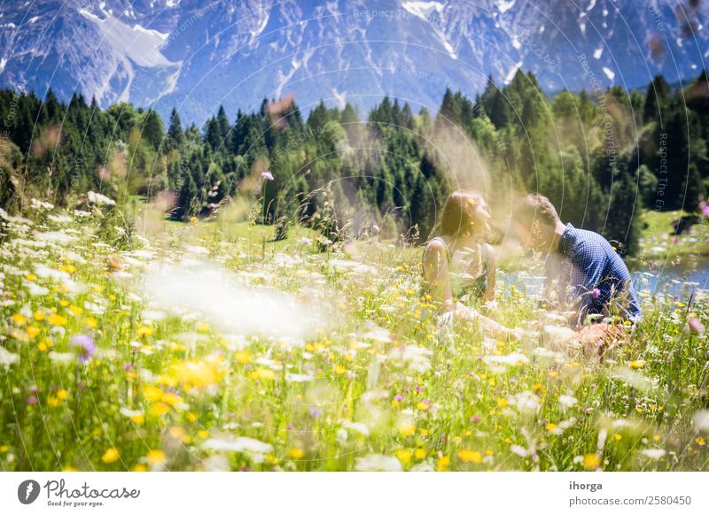happy lovers on Holiday in the alps mountains adventure background beautiful cheerful countryside couple europe female field flower forest girl green hands