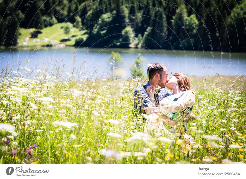 happy lovers on Holiday in the alps mountains adventure background beautiful cheerful countryside couple europe female field flower forest girl green hands