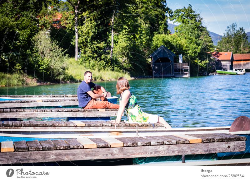 Two happy lovers on vacation at the pier on a lake Lifestyle Happy Beautiful Relaxation Vacation & Travel Adventure Summer Mountain Woman Adults Man Couple