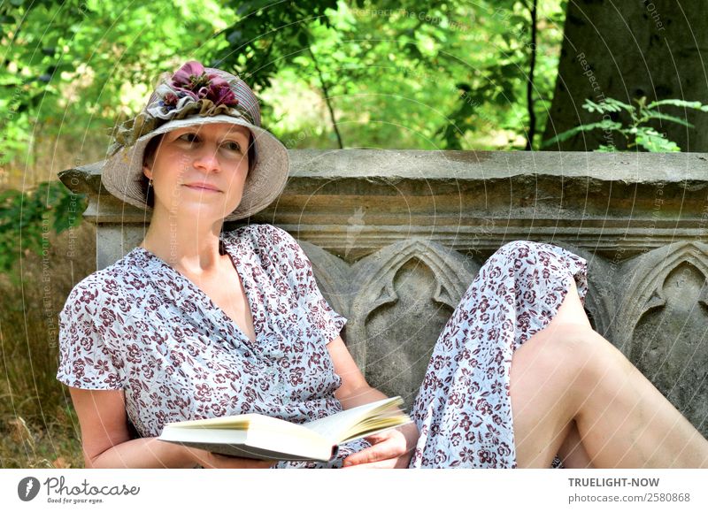 Woman with book and hat on historical stone bench Lifestyle Elegant Style Joy Beautiful Harmonious Well-being Contentment Relaxation Calm Leisure and hobbies