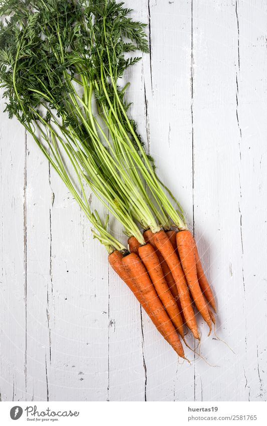 Fresh carrots on a white background Food Vegetable Nutrition Eating Vegetarian diet Diet Nature Wood Delicious Natural Above Green Orange White Carrot