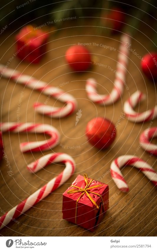 Candy canes with Christmas balls Dessert Design Joy Happy Winter Decoration Feasts & Celebrations Christmas & Advent Wood Ornament Stripe Bright Red White