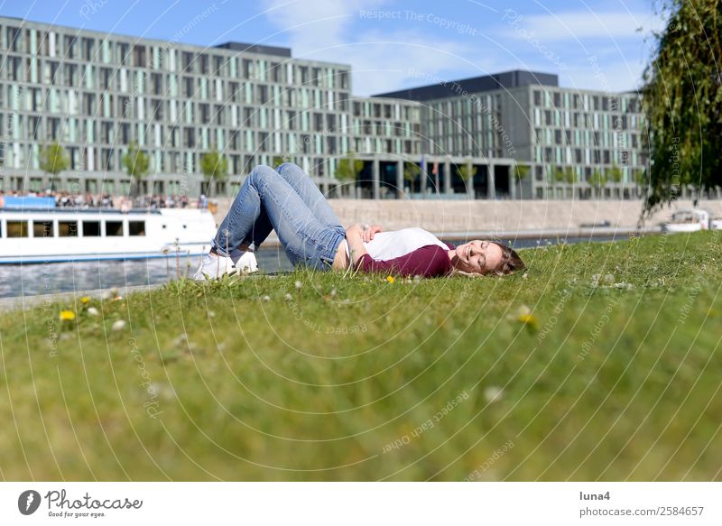 Woman lies at the river Lifestyle Joy Happy Beautiful Contentment Relaxation Leisure and hobbies Tourism Summer Young woman Youth (Young adults) Adults Meadow