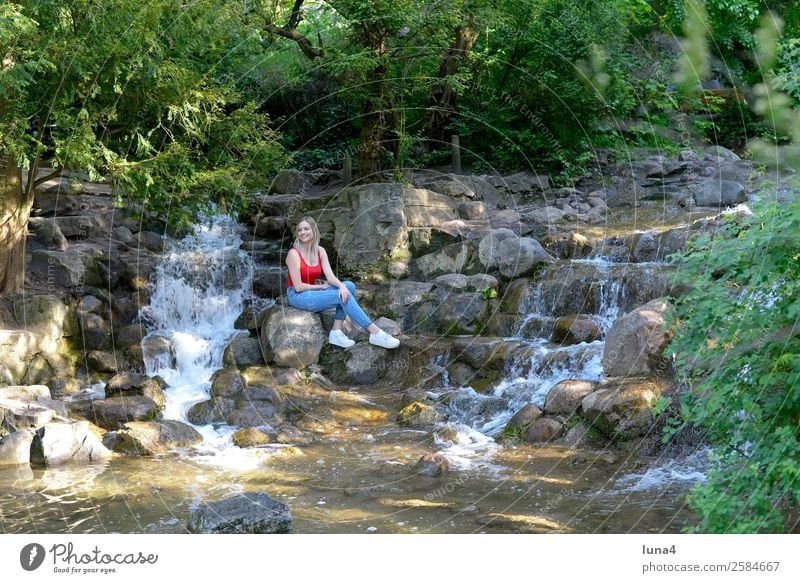 Woman sitting at the waterfall Lifestyle Joy Happy Beautiful Contentment Relaxation Leisure and hobbies Tourism Summer Young woman Youth (Young adults) Adults