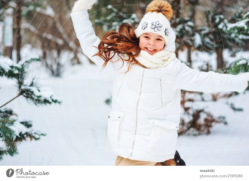 Winter portrait of happy child girl playing Joy Playing Vacation & Travel Adventure Freedom Snow Winter vacation Child Infancy Nature Snowfall Park Forest