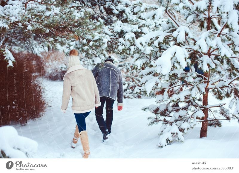 Lifestyle winter portrait of romantic couple walking Joy Vacation & Travel Adventure Freedom Winter Snow Couple Adults Nature Snowfall Park Forest Gloves