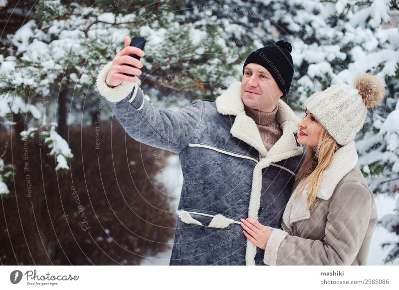 happy romantic couple making selfie outdoor in snowy winter Lifestyle Joy Vacation & Travel Adventure Freedom Winter Snow Woman Adults Man Couple Nature