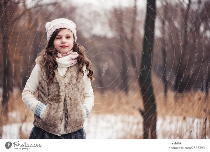 winter portrait of happy kid girl walking Lifestyle Joy Leisure and hobbies Vacation & Travel Winter Snow Child Infancy Weather Forest Fashion Hat Smiling