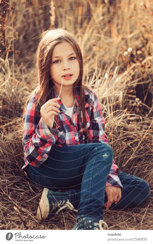 adorable kid girl in plaid shirt on sunny summer field Joy Relaxation Vacation & Travel Summer Child Woman Adults Infancy Nature Autumn Weather Warmth Leaf