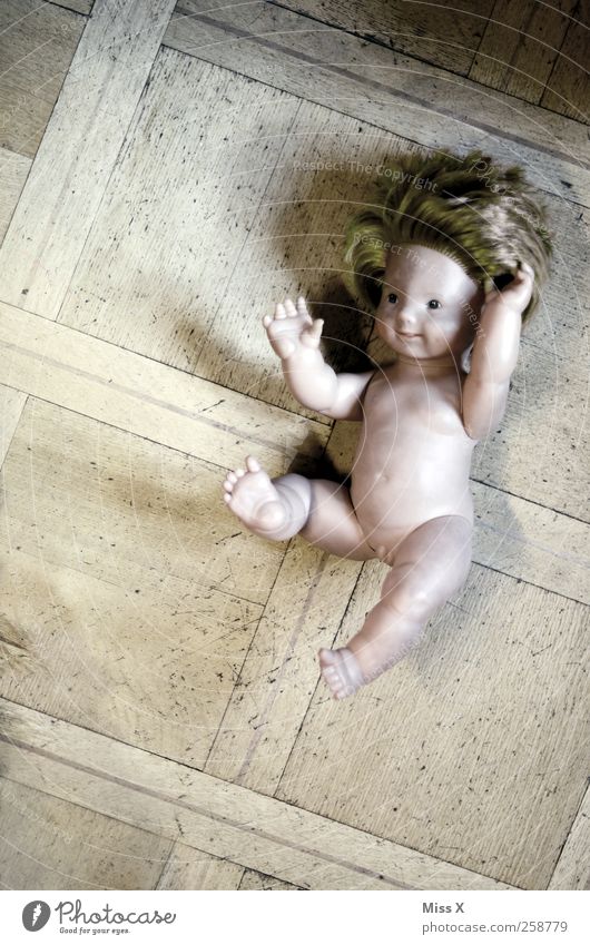 lintel Playing Children's game Smiling Lie Old Creepy Broken Trashy Doll Floor covering Sudden fall Colour photo Subdued colour Interior shot Deserted