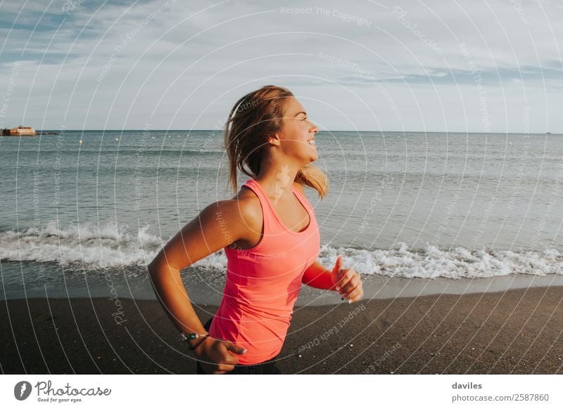 Woman with sports clothes running by the sea shore Lifestyle Joy Beautiful Athletic Fitness Wellness Summer Sun Beach Ocean Sports Jogging Human being Feminine