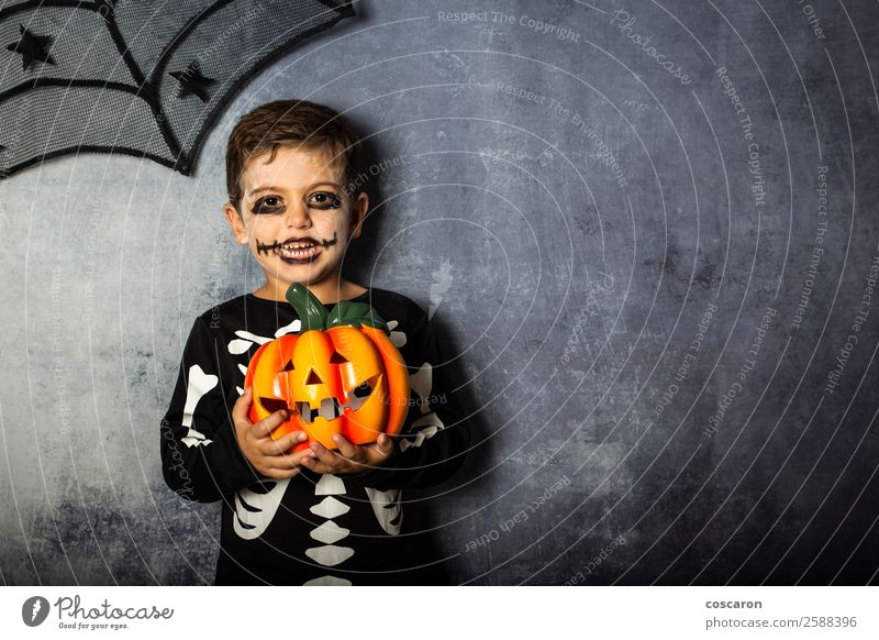 Young boy in the Skeleton costume holding Halloween pumpkin Joy Beautiful Face Life Decoration Feasts & Celebrations Carnival Hallowe'en Child Internet