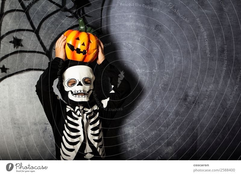 Young boy in the Skeleton costume holding Halloween pumpkin Joy Beautiful Face Life Leisure and hobbies Decoration Feasts & Celebrations Valentine's Day