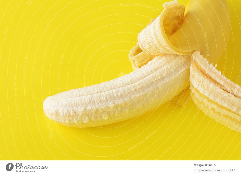 Top view. Peeled banana on yellow background. Healty concept Fruit Nutrition Eating Breakfast Vegetarian diet Diet Exotic Skin Nature Fresh Delicious Natural
