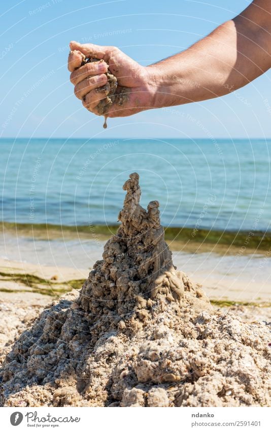 castle from the wet sea sand Joy Relaxation Playing Vacation & Travel Tourism Summer Sun Beach Ocean Hand Nature Landscape Sand Sky Coast Castle Drop Build Blue