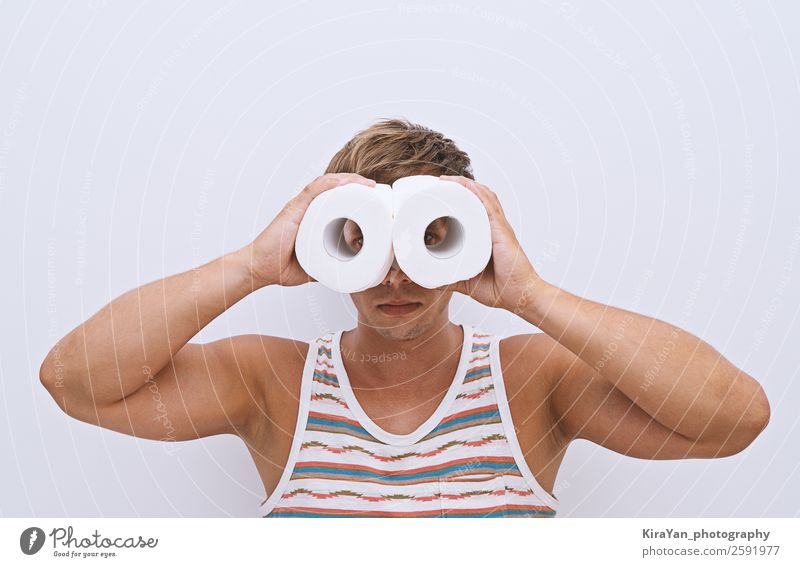 Handsome guy looks through rolls of toilet paper and simulating binoculars Happy Face Vacation & Travel Bathroom Human being Man Adults Paper Binoculars Smiling