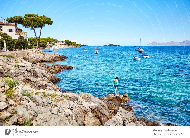 Summer holidays landscape with woman walking on rocks. Beautiful Vacation & Travel Tourism Trip Adventure Freedom Sightseeing Expedition Beach Ocean Island