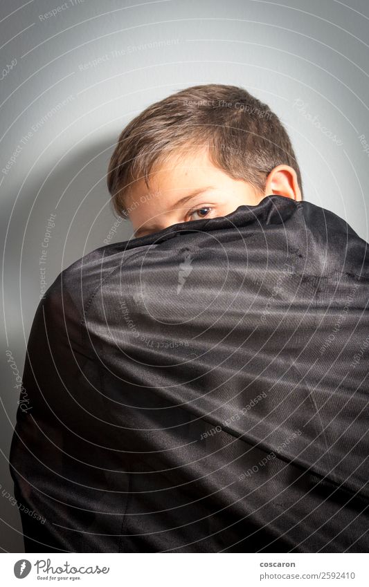 Boy covering himself with vampire cloak at Halloween Joy Face Feasts & Celebrations Carnival Hallowe'en Fairs & Carnivals Child Boy (child) Man Adults Cute