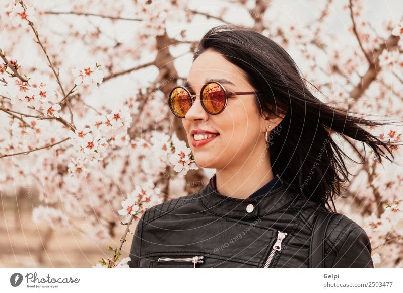 Brunette girl Style Happy Beautiful Face Garden Human being Woman Adults Nature Tree Flower Blossom Park Fashion Jacket Leather Sunglasses Smiling Happiness